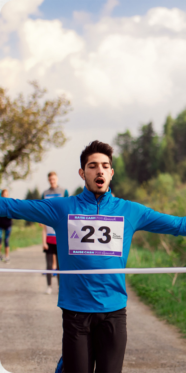 Runner crossing finish line at the 5K Fun Run