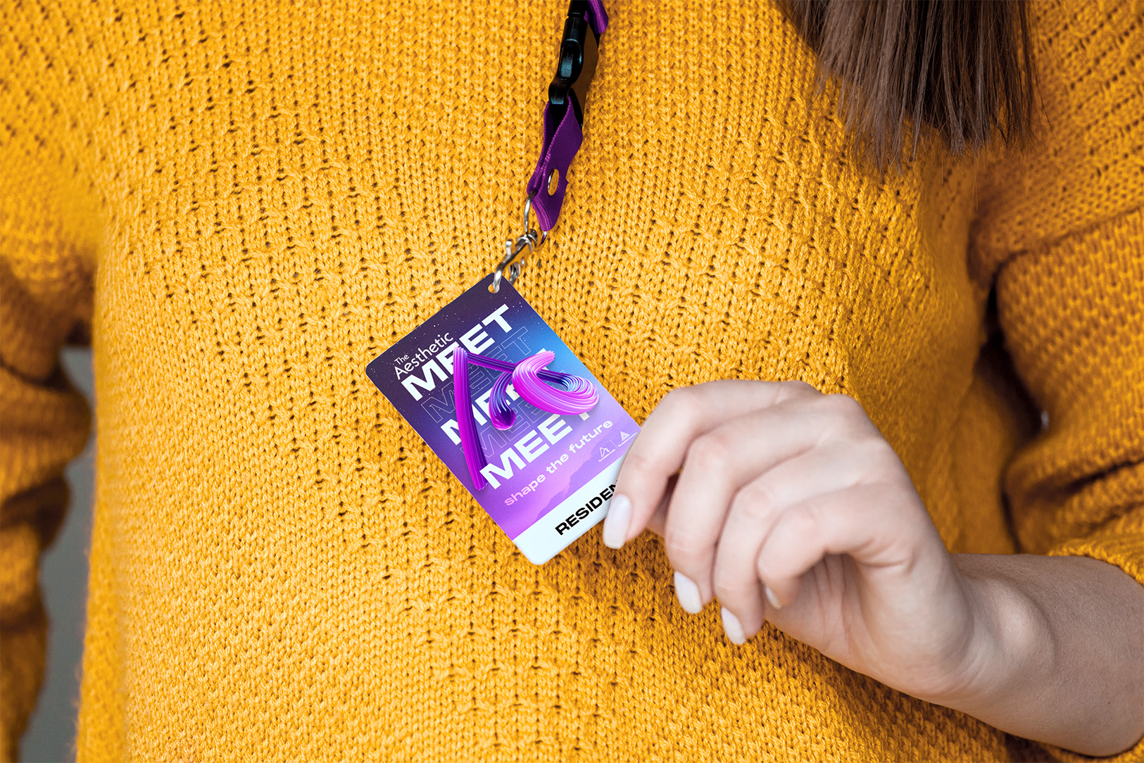 Conference badge on yellow sweater